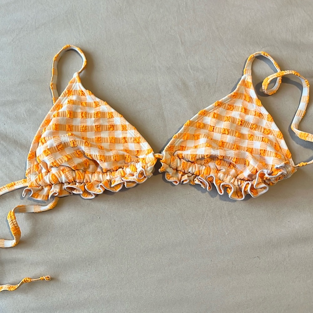 The brand wild fable in a size xs and is orange and white stripes